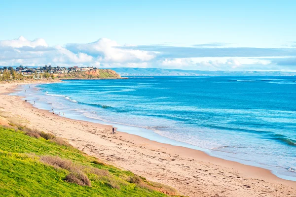 People walking along the beach Stock Image