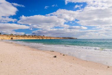 Scenic coastline at Port Willunga with turquoise water and white clouds, Fleurieu Peninsula, South Australia