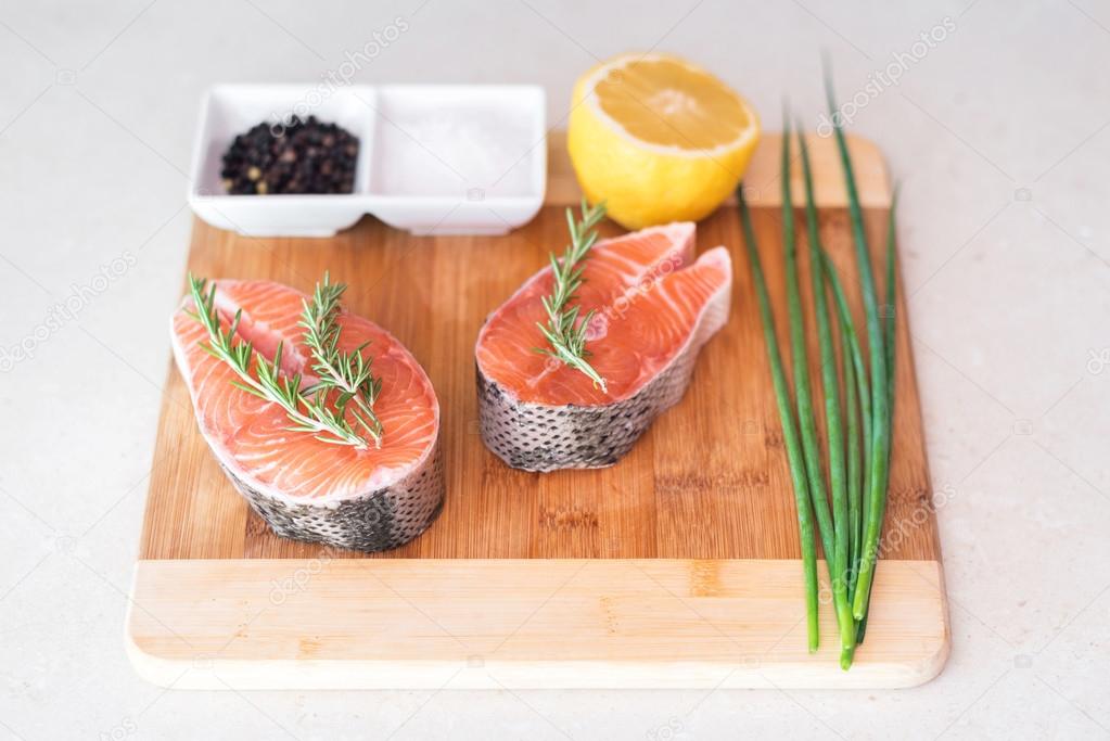 Raw salmon fish steak on table