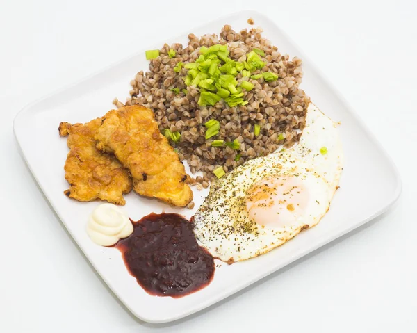 Boiled buckwheat with omelet, chicken chops and sour sauce — Stock Photo, Image