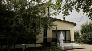 Verandada elma bahçesi, bir ev ve bir düğün elbise.