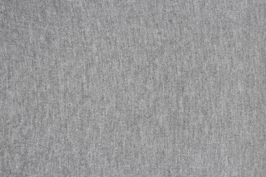 Kalıplaşmış yüzeyi ve kumaşı olan homojen gri arkaplan.