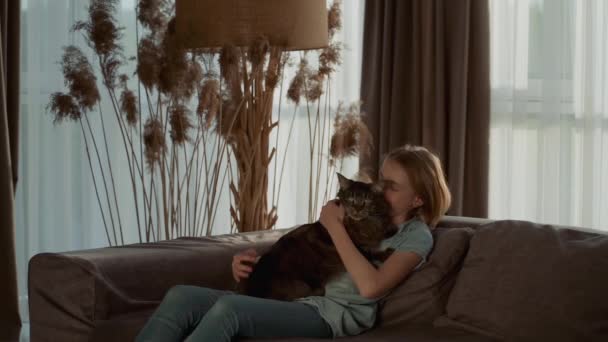 Cute Teenage Girl Petting Her Pet While Sitting Sofa Living — 图库视频影像