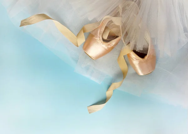 ballerina shoes pointe shoes with a tutu skirt of different colors on a blue background