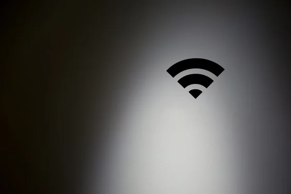 WiFi symbol in highlight concrete wall. — Stock Photo, Image