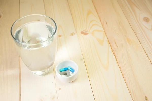 pills medicine and water glass, ready to eat.