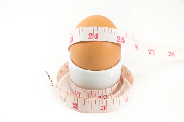 Uova e misura, uso per la dieta concenpt Foto Stock Royalty Free