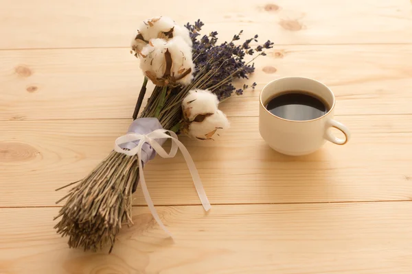 cup of coffee and lavender on a wooden tray