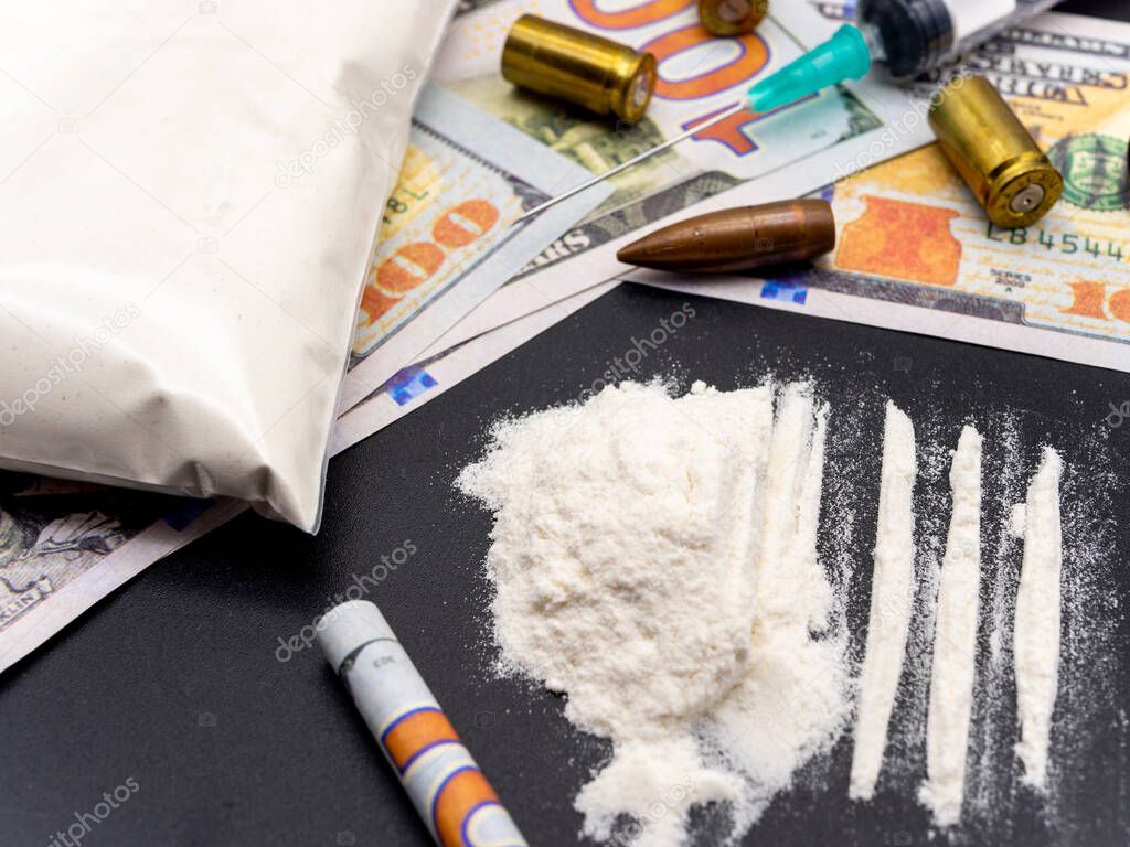 syringe hundred dollars bills cocaine heroine and pistol cartridges drug addiction social issues concept