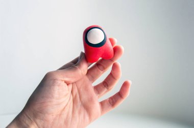 Popüler kozmonot karakteri figürünün fotoğrafı, kızın elinde tuttuğu ve onunla birlikte uçtuğu. Bir astronot ünlü modaya uygun çocuk rolünden bir arabayla uzaya uçuyor.