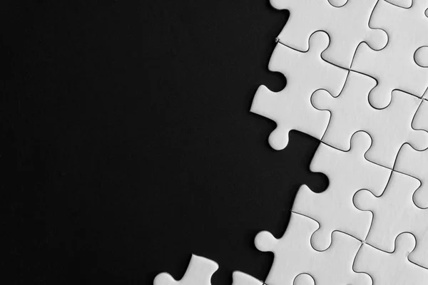 Unfinished White Jigsaw Puzzle Pieces Black Background Copy Space — Stock Photo, Image