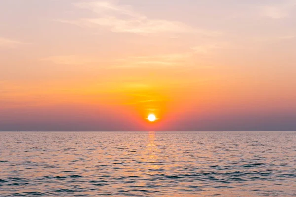 stock image Sunset reflection sea. beautiful sunset behind the clouds and blue sky above the over sea landscape background