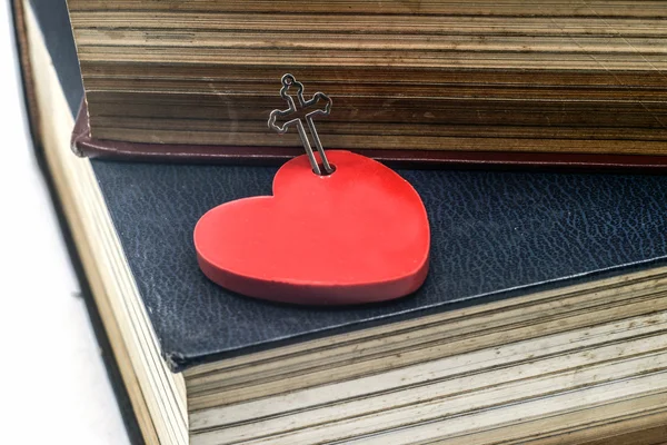 Red heart with cross and bible book — Stock Photo, Image