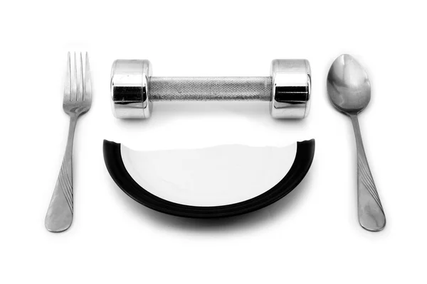 Dumbbell and a broken plate to serve for breakfast — Stok fotoğraf