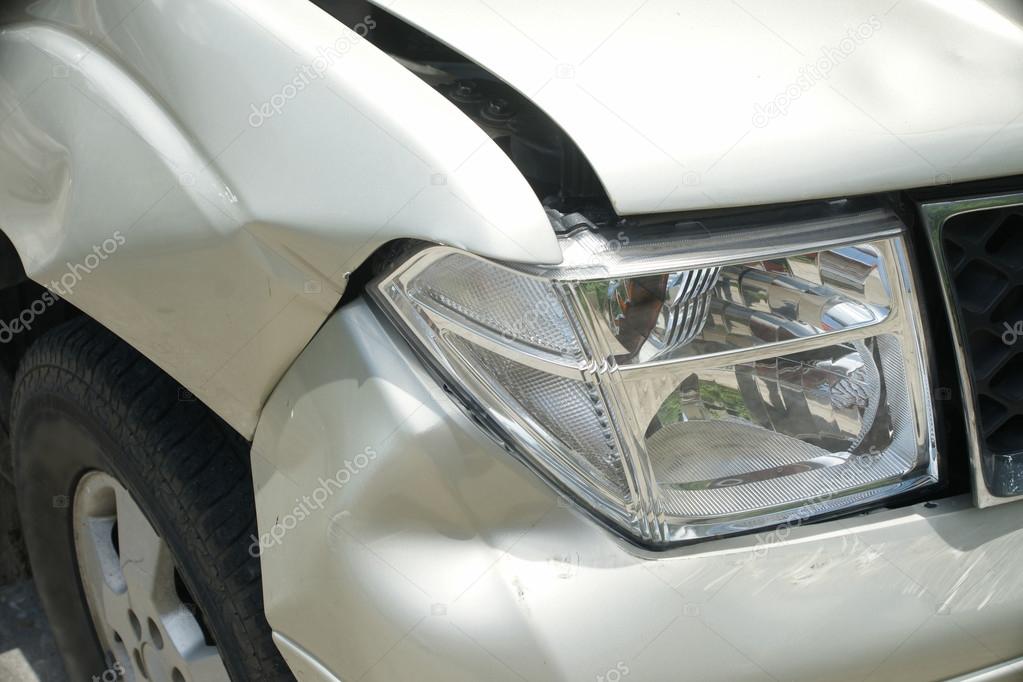 A dent on the right front of a pickup truck (damage from crash)