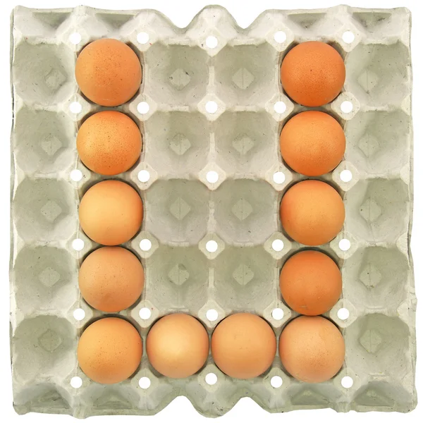 A letter U from the eggs in paper tray