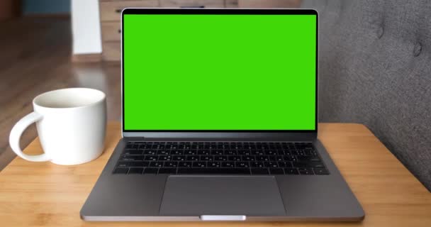 Green screen laptop computer sitting on a home work — Stock Video