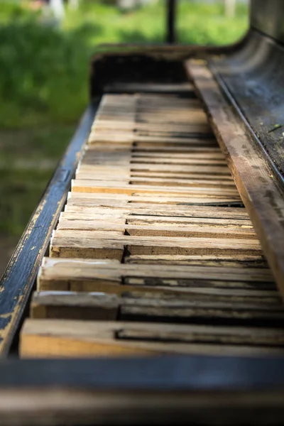 Old wooden piano as garden decor, outdoors. keys of piano