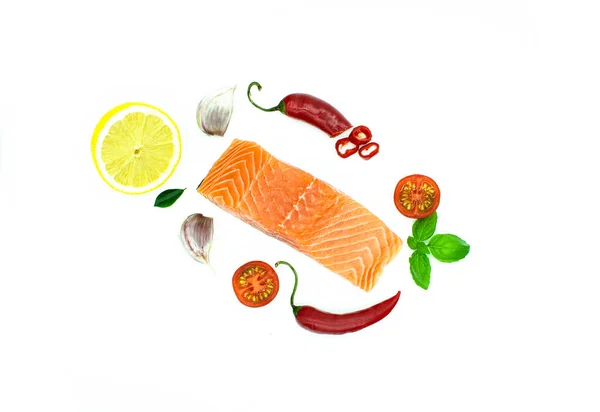 Piece of salmon isolated on white, Garlic, Red chilli pepper lemon, tomato. top — Stock Photo, Image