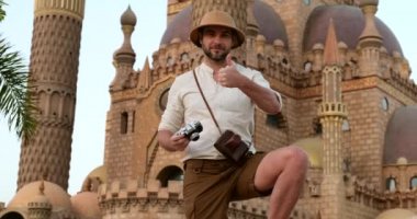 Turist, Müslüman camiinin arka planında duruyor.