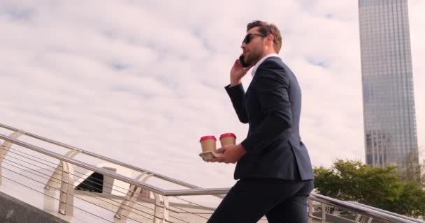 Geschäftsmann geht mit Kaffee die Treppe hinauf und telefoniert — Stockvideo