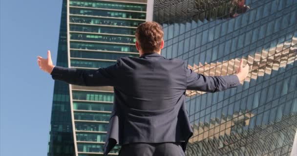 Back View of thoughtful Businessman in Suit looking at his Huge Company crypto — Stock Video