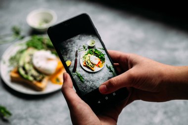 Poached egg with avocado salad, microgreen and arugula