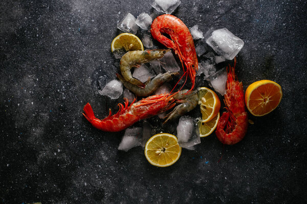 shrimp in ice with lemon on a gray background