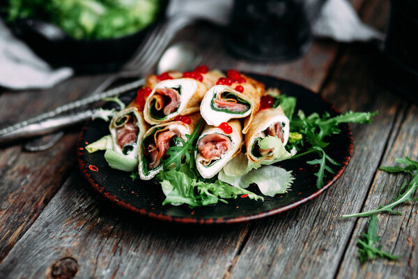 pancakes with fish, red caviar and cream cheese