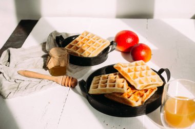  Beyaz tabakta ballı Belçika waffle 'ları ve portakal suyu. Kahvaltı