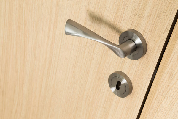 Handle and lock detail on a wooden door