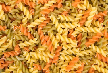Raw fusilli pasta - three colors clipart