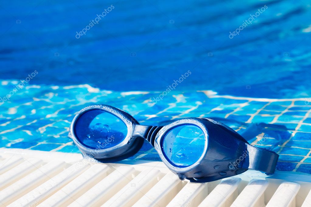 Swimming pool goggles on the poolside