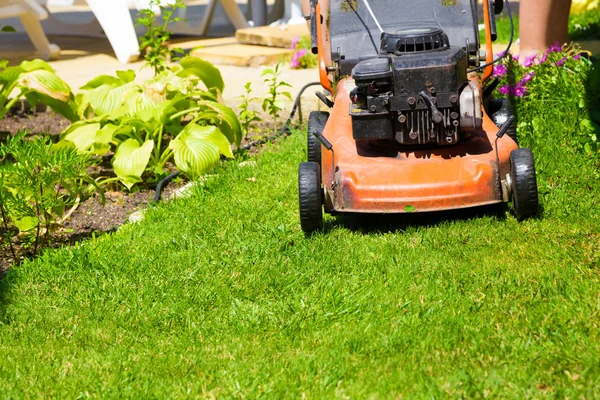 Lawn mower on a fresh lawn in the garden — Stock Photo, Image