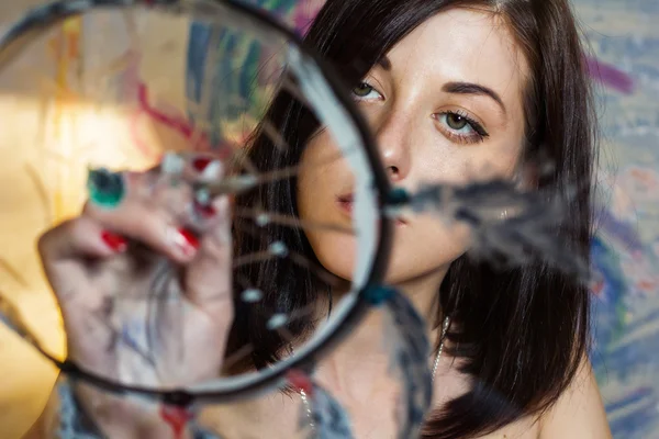 Girl artist painting on glass dream catcher — Stock Photo, Image