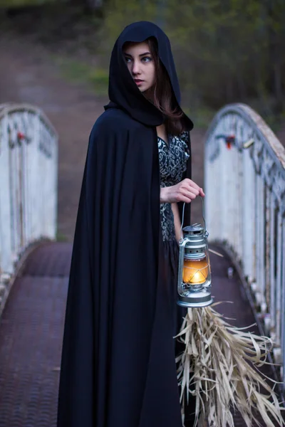 Girl with a lantern on the bridge — Stock Photo, Image