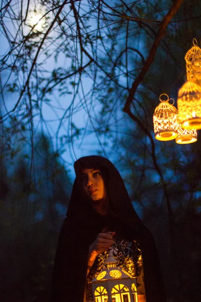 Girl with a lantern at night in the forest — Stock Photo, Image