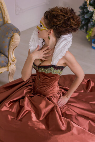 the woman in the dress of the Baroque style with a fan