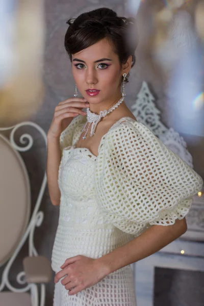 The bride in a white dress near the wall — Stock Photo, Image