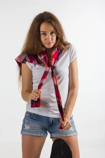 Portrait of a girl with a skateboard in the Studio — Stock Photo, Image