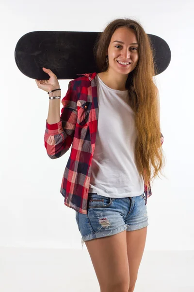 Portrait of a girl with a skateboard in the Studio Royalty Free Stock Photos