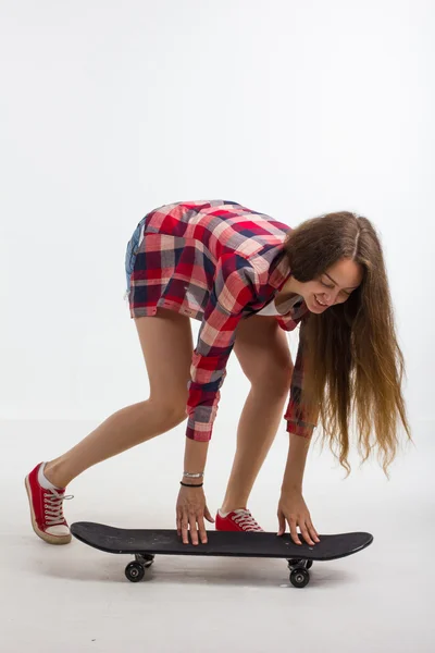 Portrait of a girl with a skateboard in the Studio Stock Photo