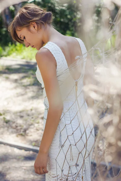 Beautiful young blonde in a white dress — Stock Photo, Image