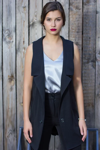 Fashionable girl in a blouse stands on the street — Stock Photo, Image