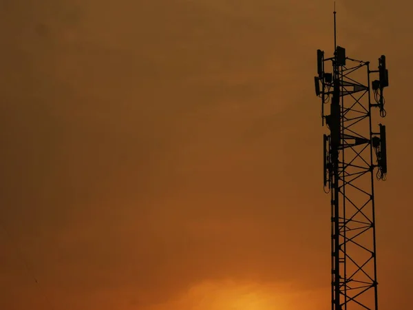 Telephone towers used to broadcast signals at dusk.