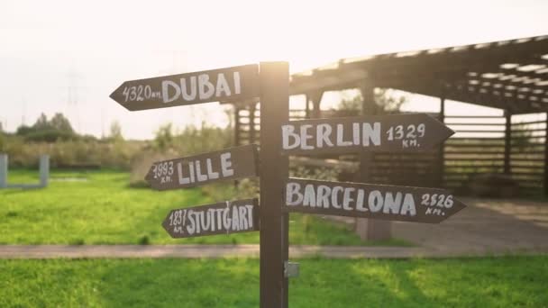 Old wooden road sign - Dubai, Berlin, Lille, Barcelona, Stuttgart