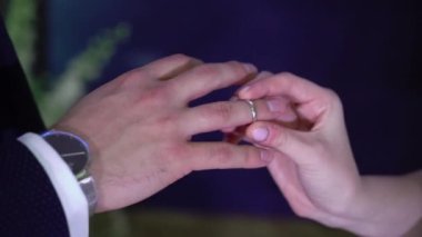 Gelin düğün töreninde damadın parmağına yüzük takar. Yüzük değişimi.