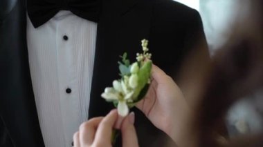 Gelin, damat için düğün günü yaka çiçeği taktı..