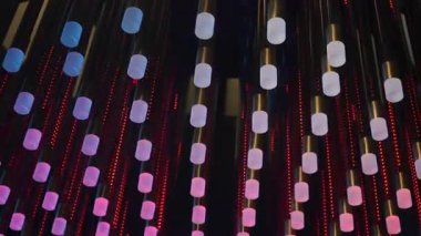 Vibrant Led Light Tunnel With Bokeh, Rows Of Suspended Glowing Capsules Shifting Magenta Blue And Amber, Slow Cinematic Upward Pan, Rhythmic