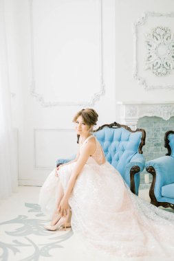 Muhteşem gelin düğün gününden önce ayakkabılarını giyer. Güne nazik bir başlangıç ve bir aile..